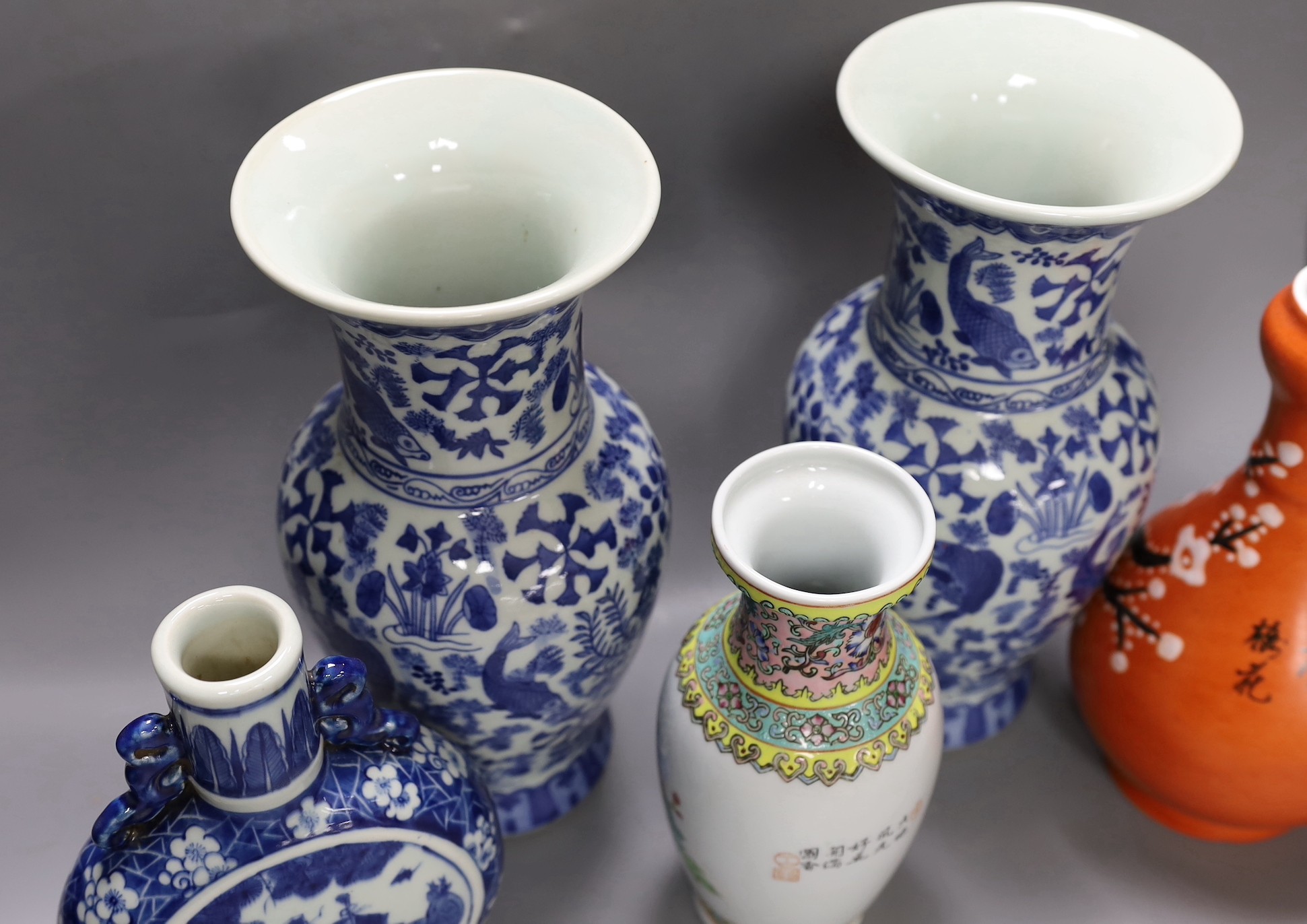 A pair of Chinese blue and white vases, two other vases and a moon flask, tallest 28cm